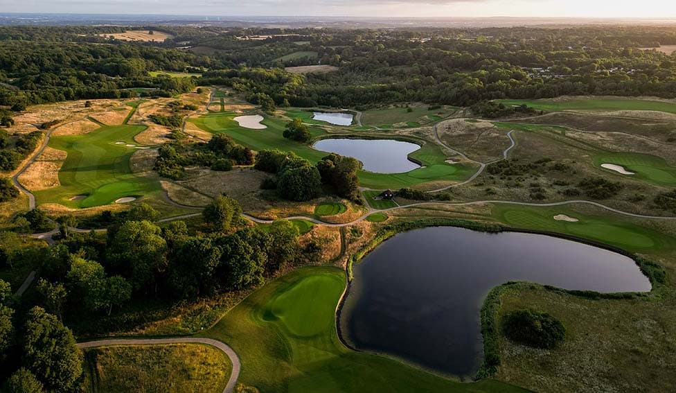 London Golf Club from the air, fairways and water at dusk.