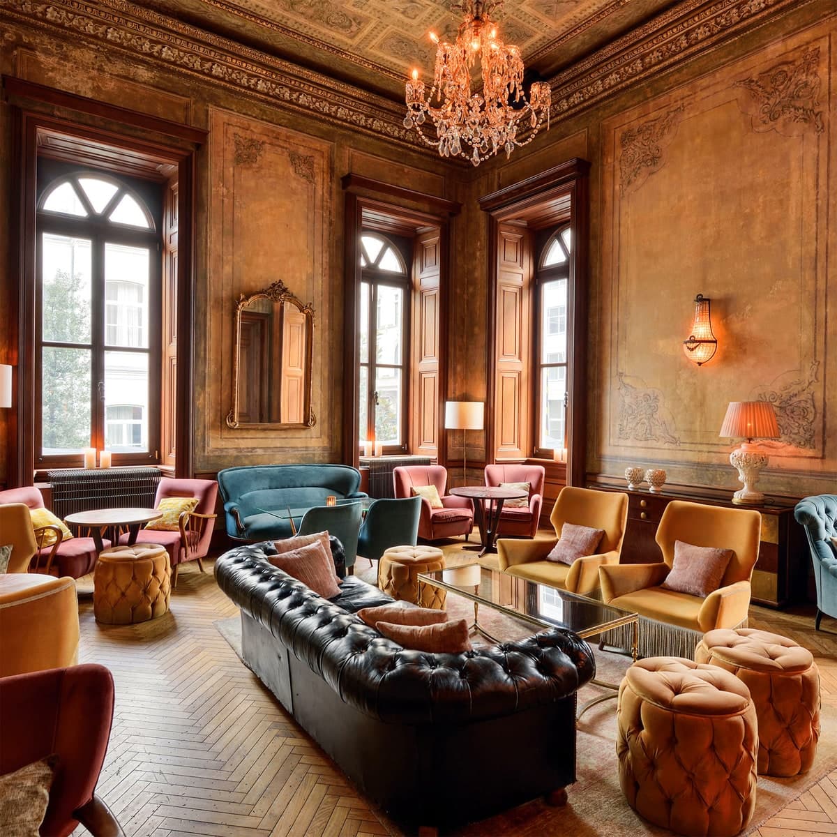 A panelled drawing room set with armchairs and low tables.